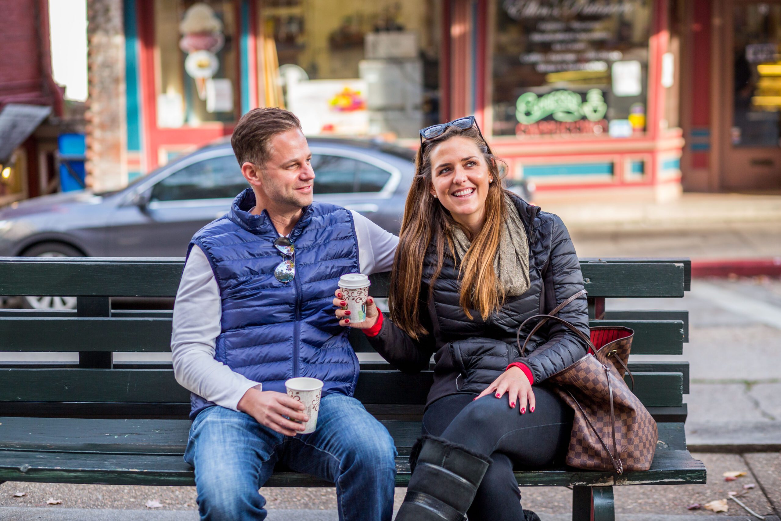 Couple-Having-Coffee-on-Bench_One